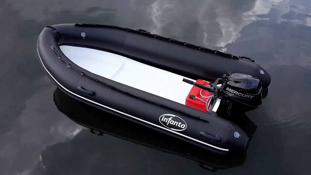 Stationery black inflatable boat on dark water